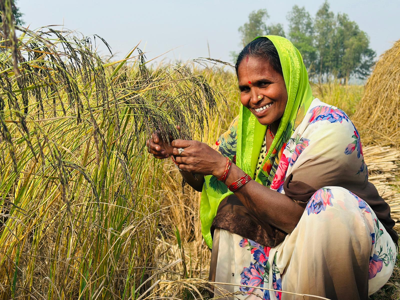 Illustration of a smiling Nepali woman holding freshly harvested greens